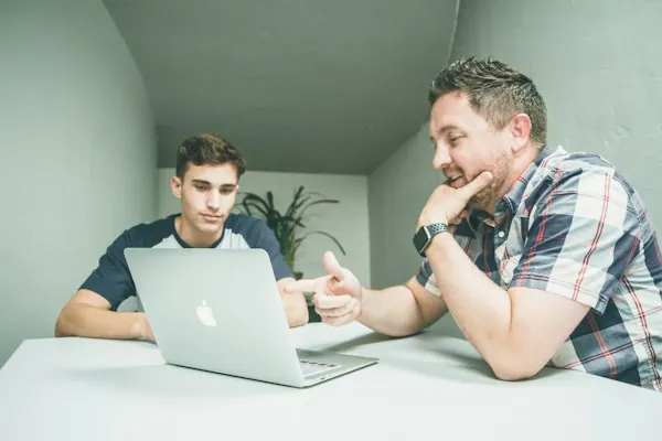 Two people negotiating across a table